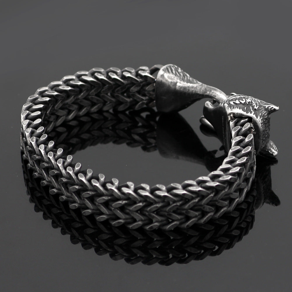 Men's wolf head bracelet in vintage black stainless steel with Cuban chain design, showcasing bold fashion jewelry for stylish wristwear.