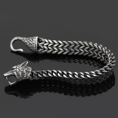 Men's jewelry bracelet with fierce wolf head and hook clasp, crafted in black stainless steel Cuban chain for a rugged vintage look.